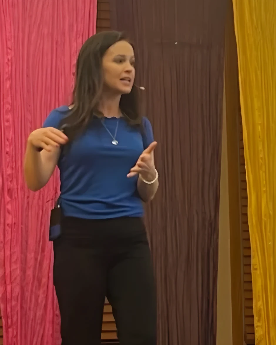 Christen teaching a retreat from the stage, with a slide on boldness from the book of Acts