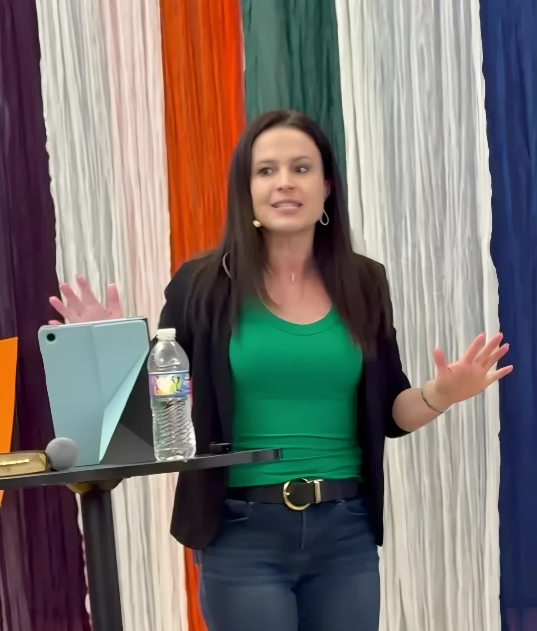 Christen teaching with an expressive open-handed gesture
